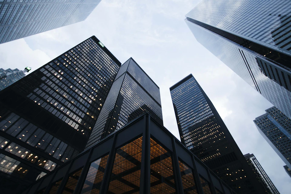 Modern glass office towers seen from street level
