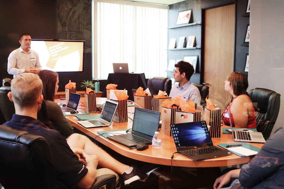 The team meeting around a boardroom table